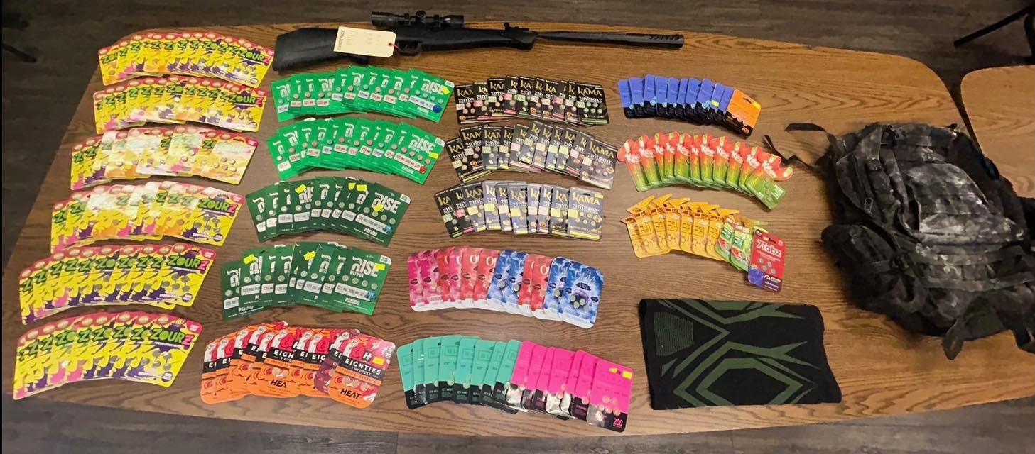 Titusville Police Department photo showing recovered synthetic concentrated 7-OH products and the machine gun used in the Smokers Palace robbery.
